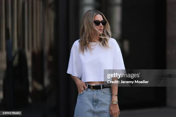 Kathrin Bommann wearing Agolde long denim skirt, Vival Studio cropped white shirt, Miu Miu black leather logo belt, Adidas samba black and white...