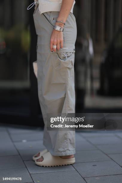 Kathrin Bommann wearing Adidas Yeezy beige rubber slides, Celine chrome silver oval shades, Chanel beige vest knit vintage top, Hermes Picotin beige...