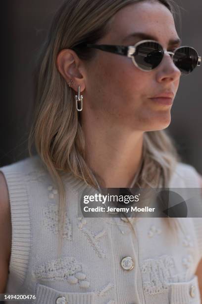 Kathrin Bommann wearing Adidas Yeezy beige rubber slides, Celine chrome silver oval shades, Chanel beige vest knit vintage top, Hermes Picotin beige...