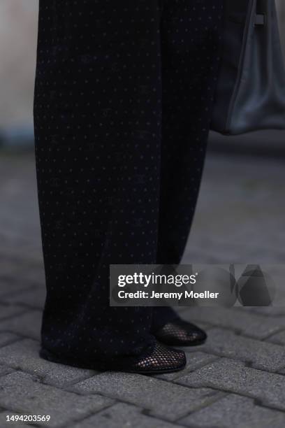 Kathrin Bommann wearing Chanel black wide leg logo denim pants, ALAÏA black mesh ballerina flats, Vival studio black cropped t shirt, Cartier tank...