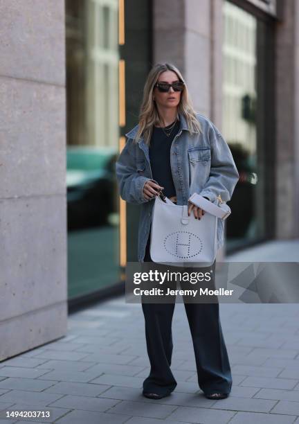 Kathrin Bommann wearing Vival Studio cropped dark grey shirt, Saint Laurent black shades, Hermes 33 Evelyne baby blue grey bag, Hermes fluffy Chypre...