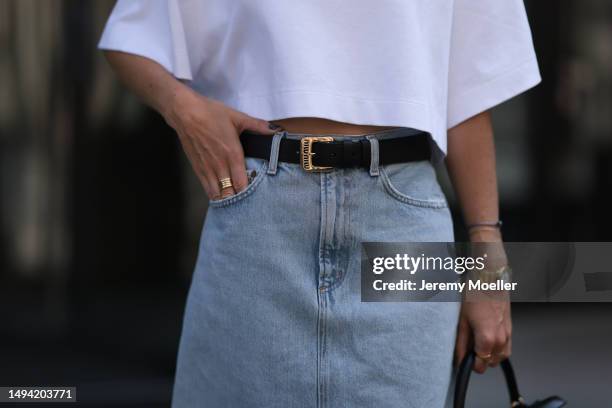 Kathrin Bommann wearing Agolde long denim skirt, Vival Studio cropped white shirt, Miu Miu black leather logo belt, Adidas samba black and white...