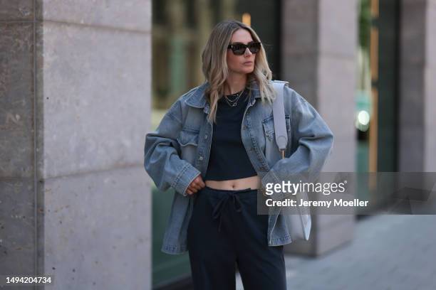 Kathrin Bommann wearing Vival Studio cropped dark grey shirt, Saint Laurent black shades, Hermes 33 Evelyne baby blue grey bag, Hermes fluffy Chypre...
