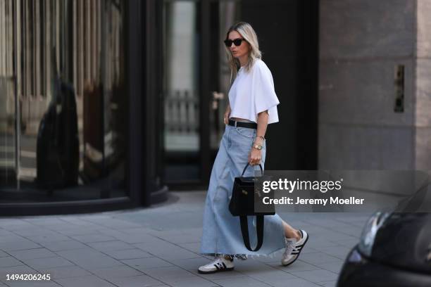 Kathrin Bommann wearing Agolde long denim skirt, Vival Studio cropped white shirt, Miu Miu black leather logo belt, Adidas samba black and white...