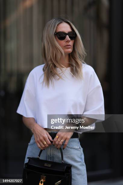 Kathrin Bommann wearing Agolde long denim skirt, Vival Studio cropped white shirt, Miu Miu black leather logo belt, Adidas samba black and white...
