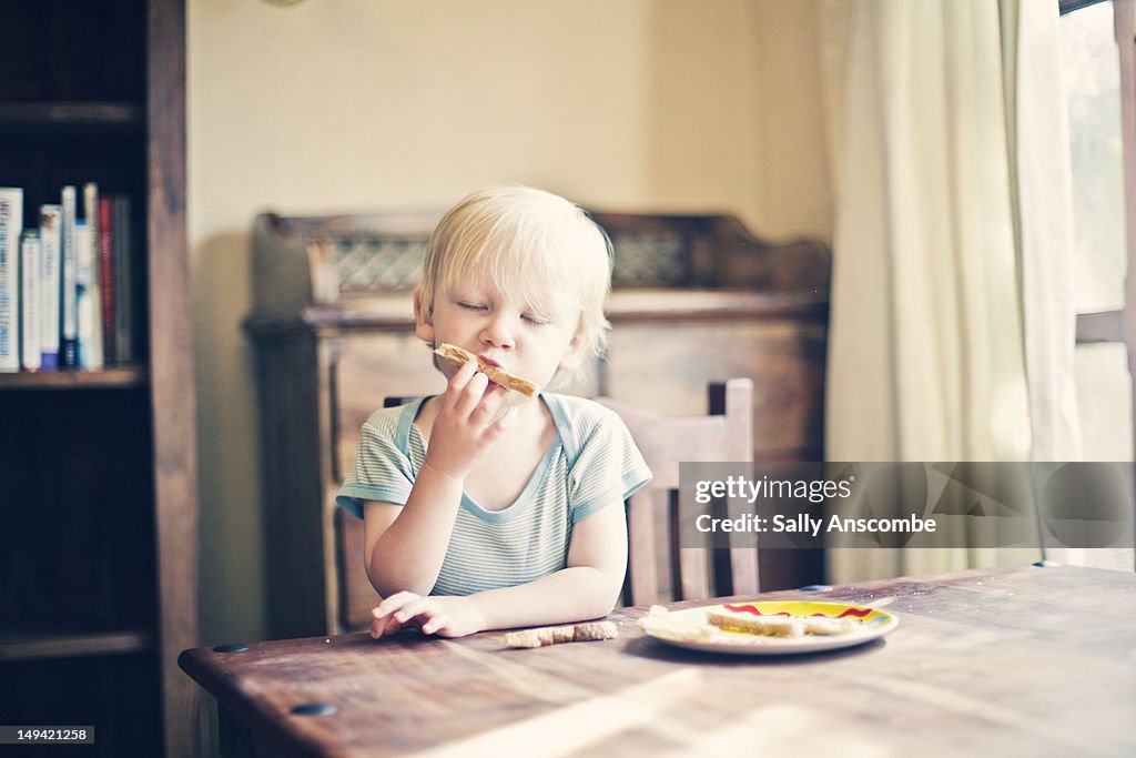 Child eating toast for breakfast