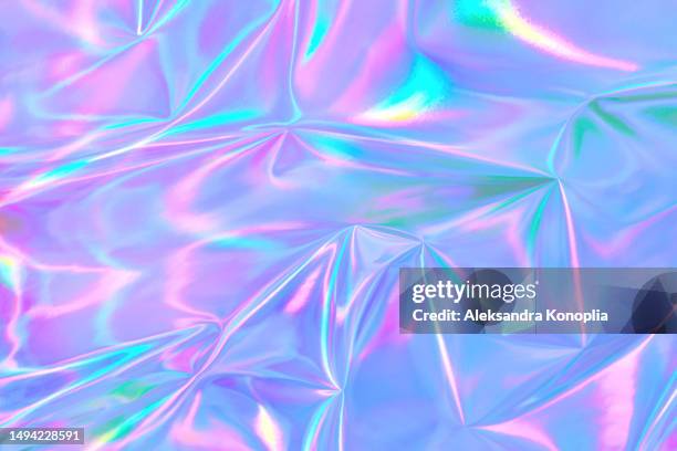 abstract ethereal pastel neon holographic blue, pink, digital lavender purple crumpled metallic foil background. - holograma fotografías e imágenes de stock