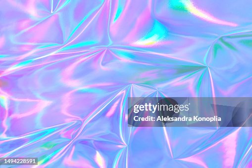 Abstract ethereal pastel neon holographic blue, pink, digital lavender purple crumpled metallic foil background. Abstract ethereal pastel neon holographic blue, pink, digital lavender purple crumpled metallic foil background.