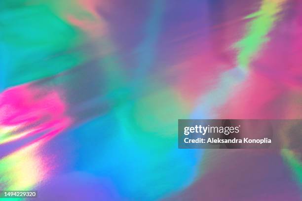 abstract neon blue, purple, green, pink glowing holographic foil texture. futuristic, retro, glowwave, acidwave, 80s, 90s, y2k,  disco, rave background. - iridescent stockfoto's en -beelden