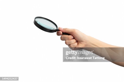 Hand holding magnifying glass isolated on white background