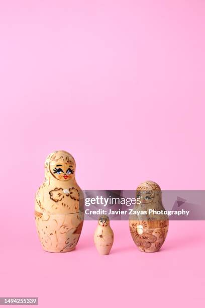 matryoshka dolls on pink background - babushka stock pictures, royalty-free photos & images