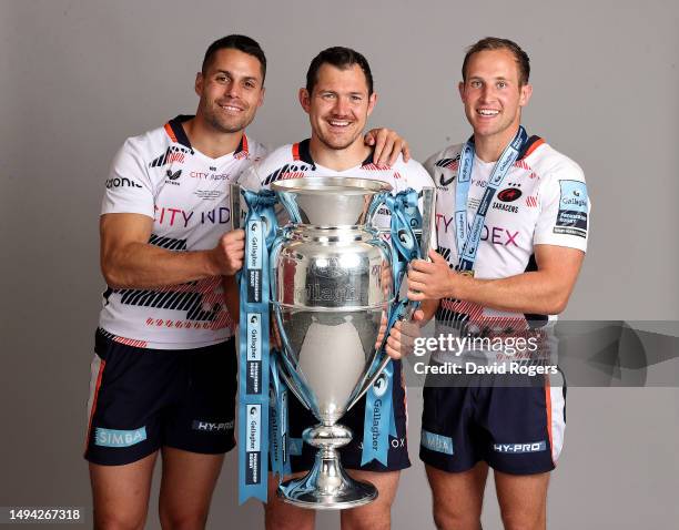 Sean Maitland, Alex Goode and Max Malins of Saracens pose with the Premiership Trophy after their victory during the Gallagher Premiership Final...