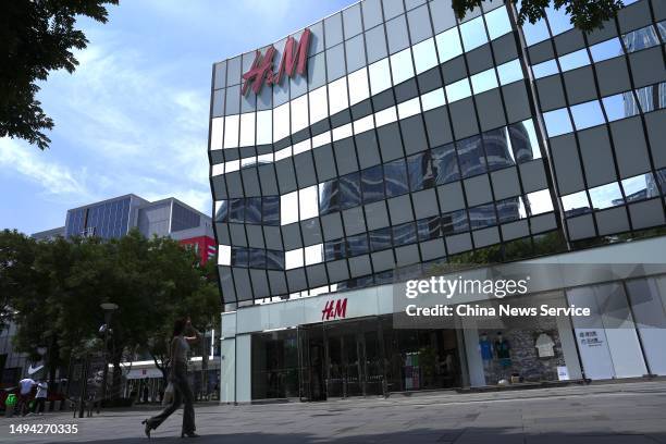 People walk past an H&M clothing store at Sanlitun on May 29, 2023 in Beijing, China.