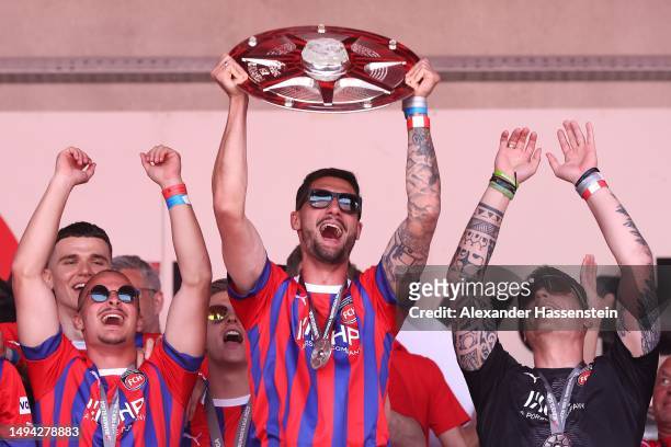 Tim Kleindienst of FC Heidenheim lifts the Meisterschale trophy at the celebration party at Voith-Arena on May 29, 2023 in Heidenheim, Germany. The...