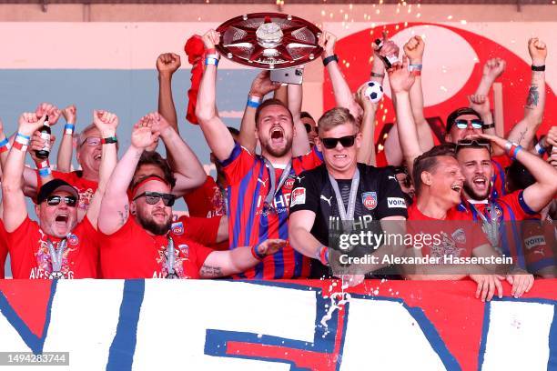 Patrick Mainka of FC Heidenheim lifts the Meisterschale trophy at the celebration party at Voith-Arena on May 29, 2023 in Heidenheim, Germany. The...