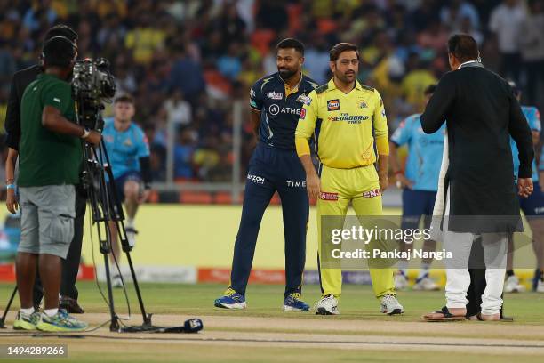 Hardik Pandya of the Gujarat Titans and MS Dhoni of the Chennai Super Kings are interviewed at the coin toss during the 2023 IPL Final match between...