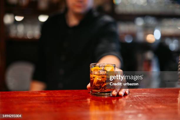 bartender serving whiskey on a bar counter - man whisky stock pictures, royalty-free photos & images