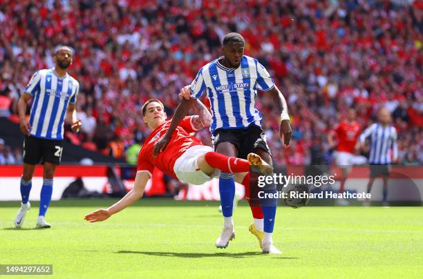 Dominic Iorfa of Sheffield Wednesday is challenged by Slobodan Tedic of Barnsley during the Sky Bet League One Play-Off Final between Barnsley and...