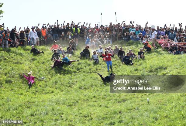 Participants take part in the first Cooper's hill women's downhill race on May 29, 2023 in Gloucester, United Kingdom. This year, with no police or...