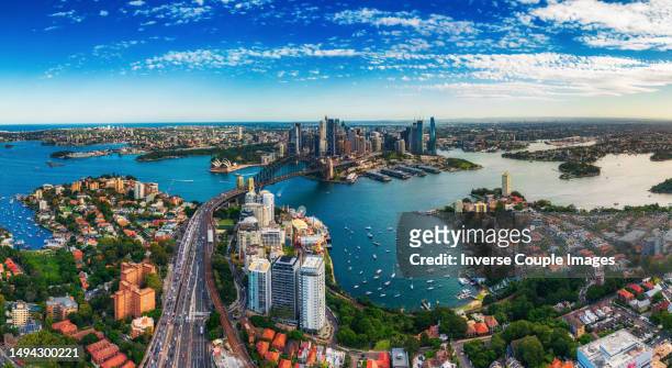 panorama aerial view scene of crowded traffic over express way heading to sydney harbour bridge with opera house, lavender bay with many yacht and circular quay - sydney opera house people stock pictures, royalty-free photos & images