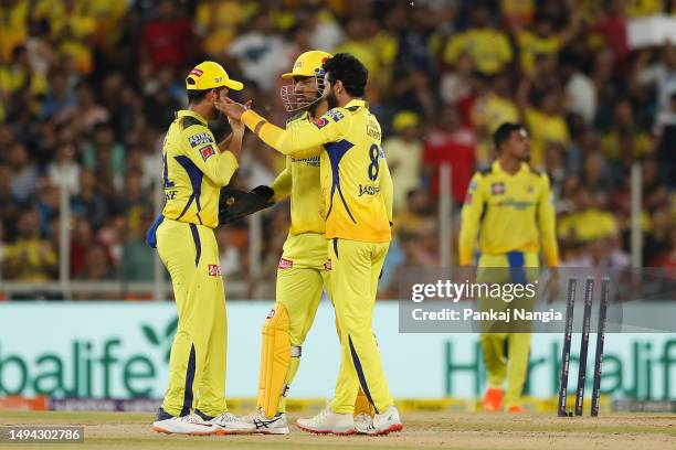 Ajinkya Rahane, MS Dhoni and Ravindra Jadeja of the Chennai Super Kings celebrate the wicket of Shubman Gill of the Gujarat Titans during the 2023...