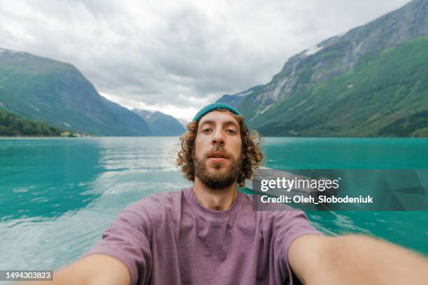 selfie of man on the background of lake in norway - moment of silence stockfoto's en -beelden