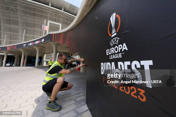 An outside view of the stadium as branding is set prior to the UEFA Europa League 2022/23 final match between Sevilla FC and AS Roma at Puskas Arena...