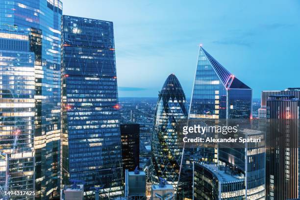 city of london skyline illuminated at dusk, aerial view, uk - cityscape stock pictures, royalty-free photos & images