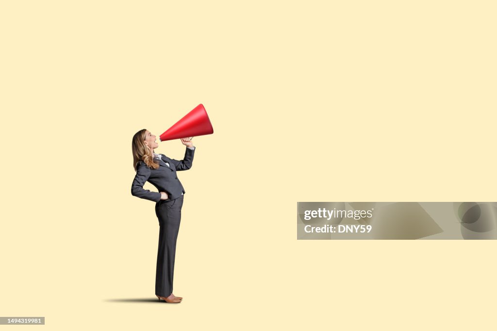 Woman With Megaphone On Yellow Background