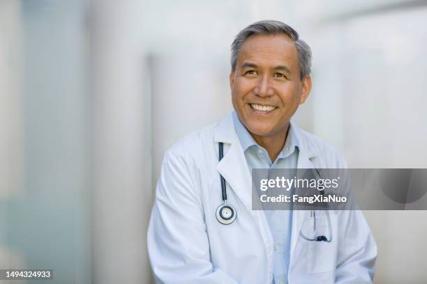 portrait of asian chinese mixed race senior mature man doctor in collared business shirt smiling looking away - face look right stock pictures, royalty-free photos & images