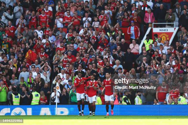 Marcus Rashford, Bruno Fernandes and Diogo Dalot of Manchester United celebrate after the teams second goal scored by Bruno Fernandes during the...
