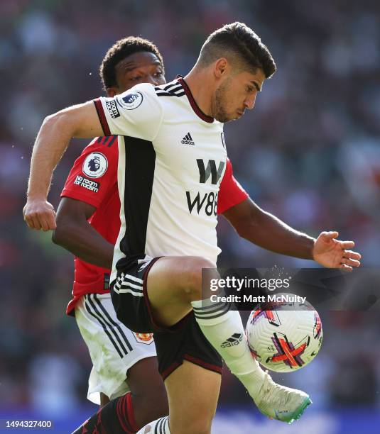 Cedric Soares of Fulham battles for possession with Tyrell Malacia of Manchester United during the Premier League match between Manchester United and...