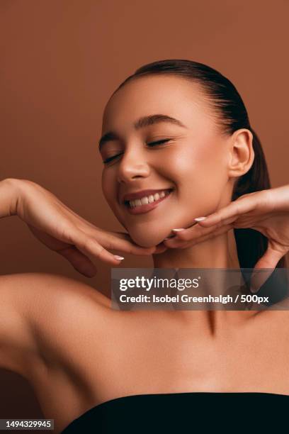 young woman with bare shoulders,manchester,united kingdom,uk - beauty treatment face stock pictures, royalty-free photos & images