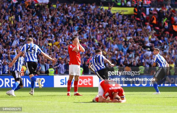 Josh Windass of Sheffield Wednesday celebrates after scoring the team's first goal as Liam Kitching and Mads Juel Andersen of Barnsley look dejected...