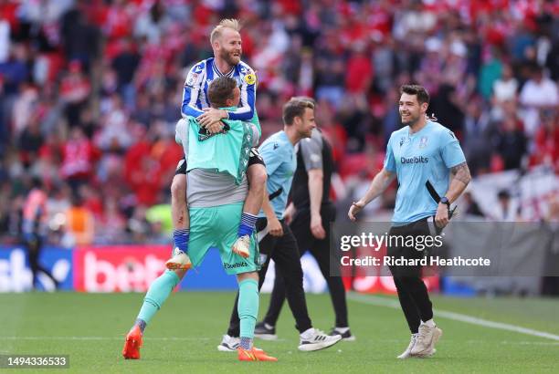 Barry Bannan of Sheffield Wednesday celebrates with teammate David Stockdale after the team's victory and promotion to the Sky Bet Championship in...