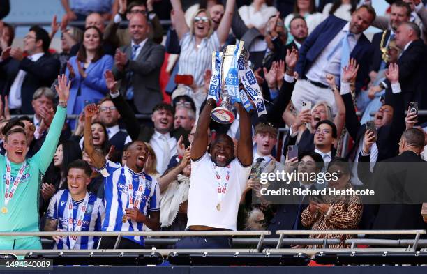 Darren Moore, Manager of Sheffield Wednesday, celebrates with the trophy alongside his players after the team's victory and promotion to the Sky Bet...