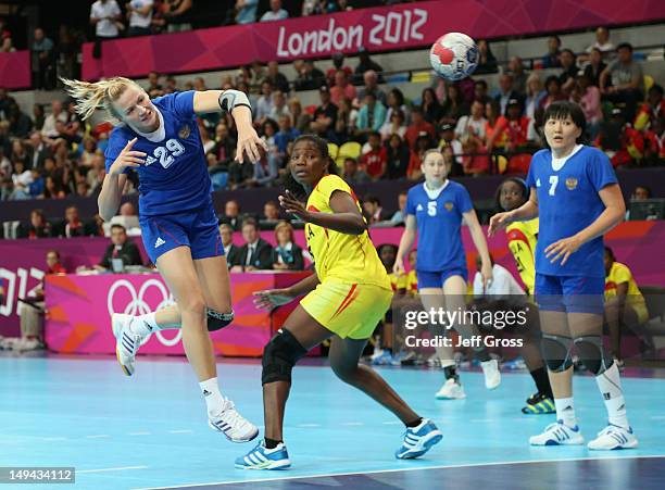 Olga Chernoivanenko of Russia shoots and scores a goal in the Women's Handball preliminaries Group A - Match 1 between Russia and Angola on Day 1 of...