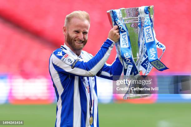 Barry Bannan of Sheffield Wednesday celebrates with the trophy after the team's victory and promotion to the Sky Bet Championship in the Sky Bet...