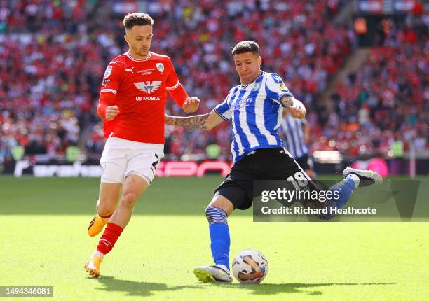 Marvin Johnson of Sheffield Wednesday passes the ball whilst under pressure from Jordan Williams of Barnsley during the Sky Bet League One Play-Off...