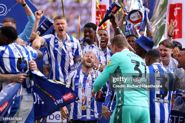 Barry Bannan of Sheffield Wednesday celebrates with teammates after the team's victory and promotion to the Sky Bet Championship in the Sky Bet...