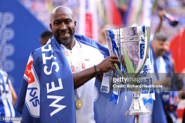 Darren Moore, Manager of Sheffield Wednesday, celebrates with the trophy after the team's victory and promotion to the Sky Bet Championship in the...