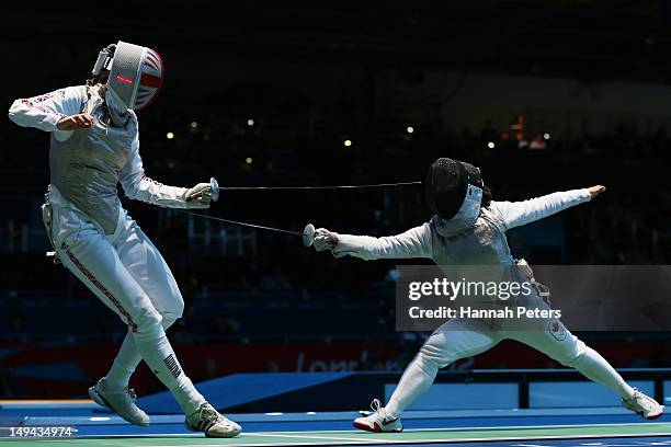 Monica Peterson of Canada competes with Anna Bentley of Great Britain in their Women's Foil Individual Round of 64 match on day one of the London...