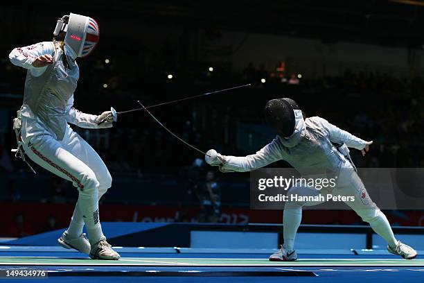 Monica Peterson of Canada competes with Anna Bentley of Great Britain in their Women's Foil Individual Round of 64 match on day one of the London...