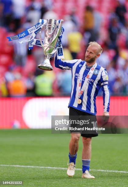 Barry Bannan of Sheffield Wednesday celebrates with the trophy after the team's victory and promotion to the Sky Bet Championship in the Sky Bet...