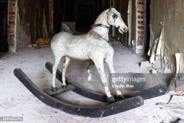 rocking horse in an abanoned building - abandoned place stock pictures, royalty-free photos & images