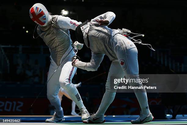 Monica Peterson of Canada competes with Anna Bentley of Great Britain in their Women's Foil Individual Round of 64 match on day one of the London...