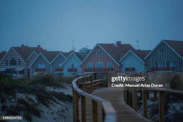 wooden footbridge leading to a fishing village - aveiro district stock pictures, royalty-free photos & images