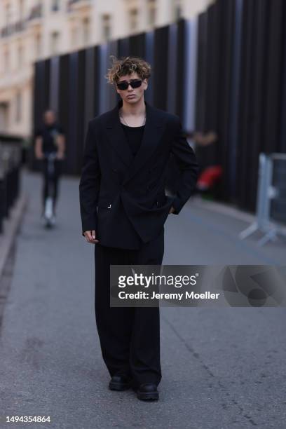 Bene Schulz is seen wearing a complete black look, black tanktop, black pants, black shades and black shoes and a black blazer and silver necklace...