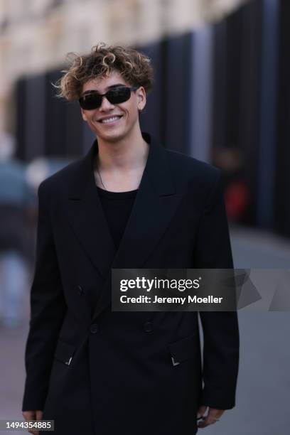 Bene Schulz is seen wearing a complete black look, black tanktop, black pants, black shades and black shoes and a black blazer and silver necklace...