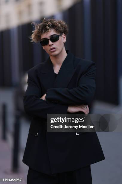 Bene Schulz is seen wearing a complete black look, black tanktop, black pants, black shades and black shoes and a black blazer and silver necklace...